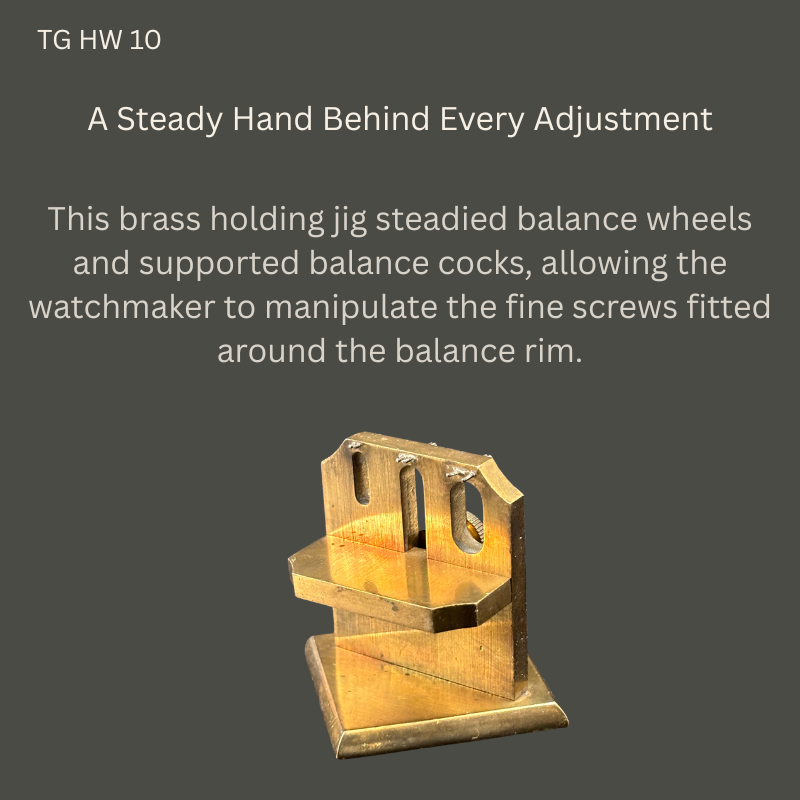 Vintage watchmaker’s brass holding jig, TG HW 10, showing a slotted upright plate, projecting support shelf and rectangular base against a dark grey background.