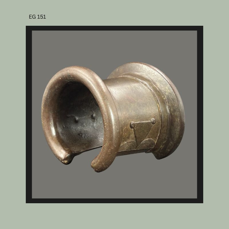 West African cast bronze open-form anklet or bracelet with flared terminals and incised geometric decoration, featuring a heavy circular form with smooth patinated surface from the Egon Guenther Collection.
