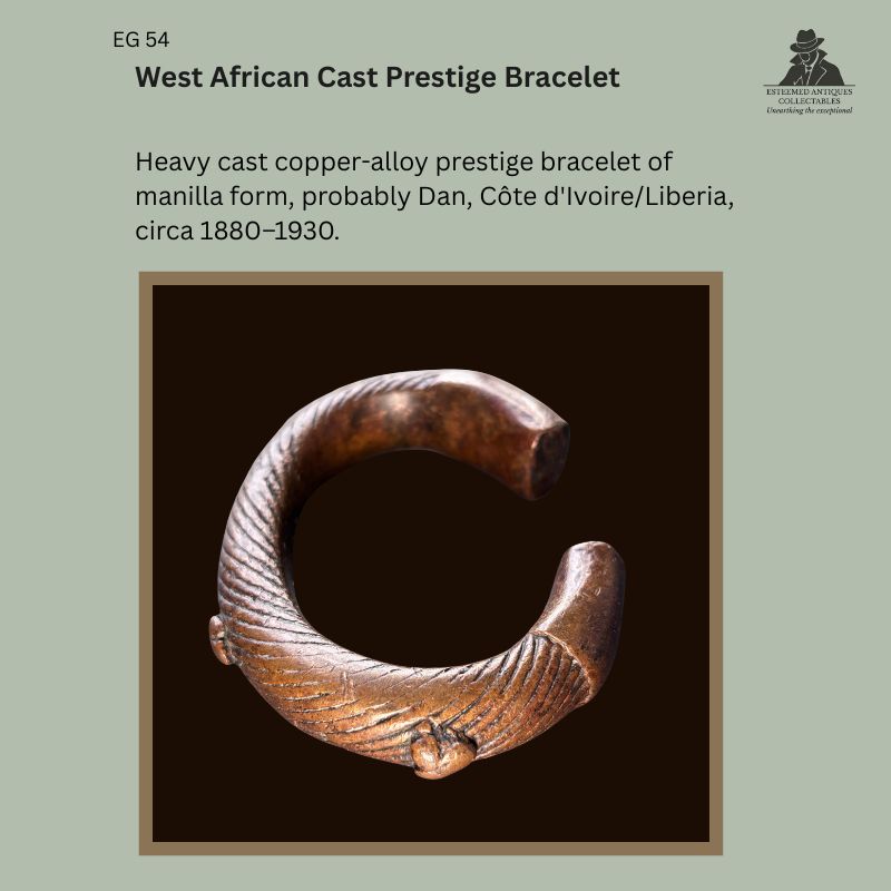 Heavy lost-wax cast copper-alloy prestige bracelet in manilla form, probably Dan, Côte d'Ivoire or Liberia, with finely incised spiral decoration and projecting cast lugs, dating to the late 19th or early 20th century. Provenance: Egon Guenther Collection, by family descent to the Thomas Guenther Collection.
