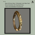 West African cast brass bracelet produced by the lost-wax casting technique, featuring a stylised human face terminal with raised cranial element and ring-form body, showing aged surface patina and wear consistent with long use, from the Hans Himmelheber provenance collection.