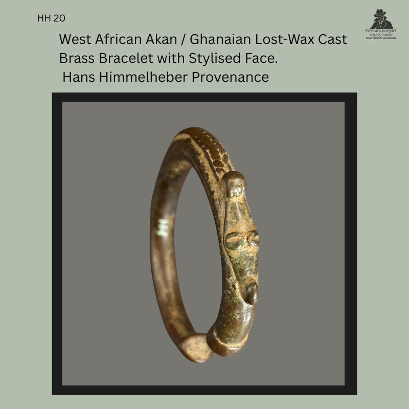 West African cast brass bracelet produced by the lost-wax casting technique, featuring a stylised human face terminal with raised cranial element and ring-form body, showing aged surface patina and wear consistent with long use, from the Hans Himmelheber provenance collection.