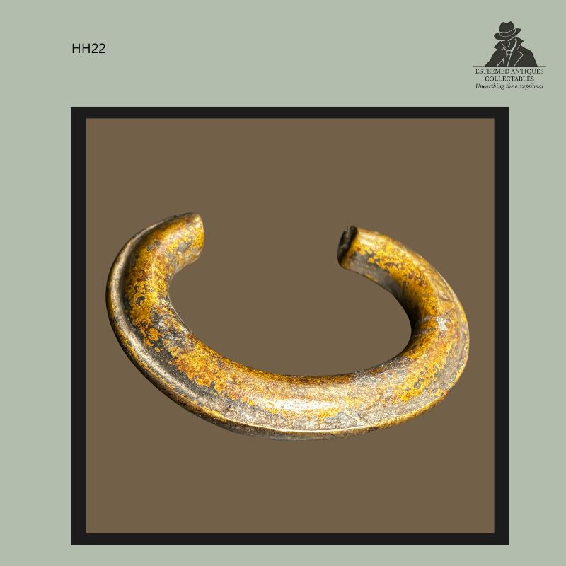 Top view of a heavy West African cast brass currency bracelet with open-ended crescent form, produced using the lost-wax casting technique and bearing a worn aged surface. Provenance: Hans Himmelheber Collection, later Egon Guenther Collection and Thomas Guenther Collection.