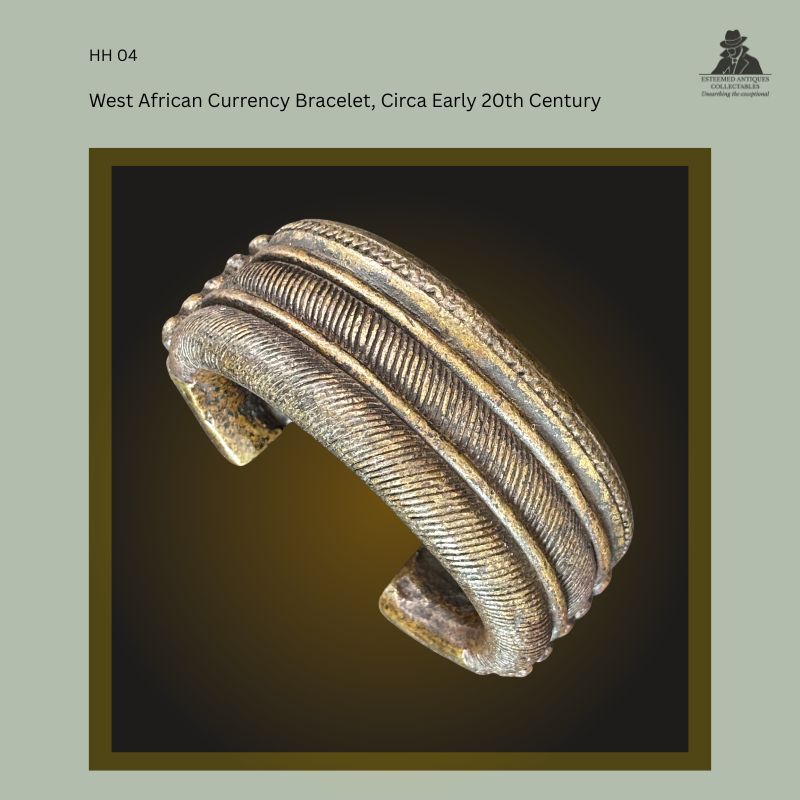Oblique view of a West African cast brass manilla currency bracelet with closely ribbed bands and open-ended form, dating to the early 20th century. From the Hans Himmelheber Collection, later the Egon Guenther Collection, and by family descent to the Thomas Guenther Collection.