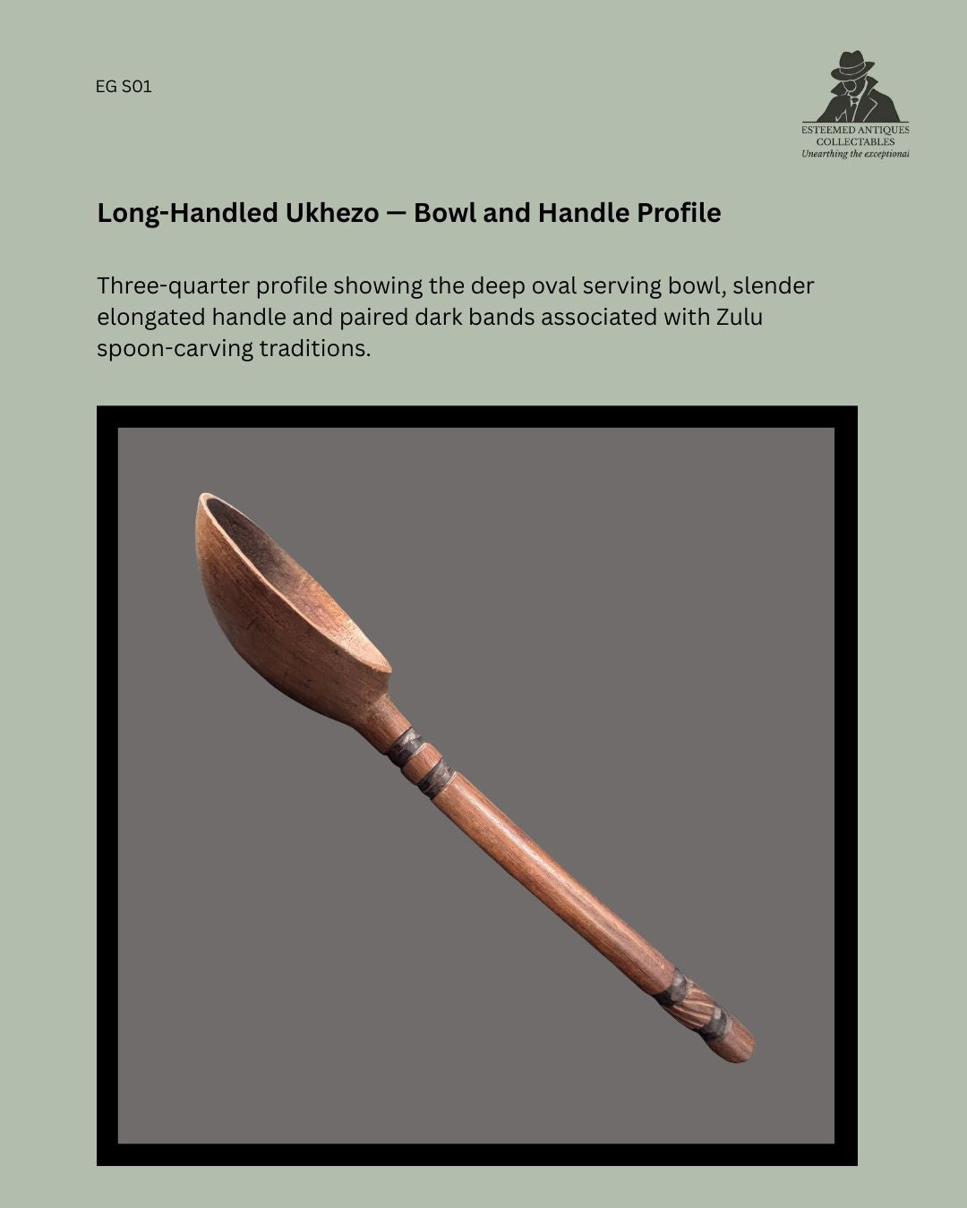 Three-quarter profile of a long-handled Zulu ukhezo wooden serving spoon, showing the deep oval bowl, slender carved handle and paired dark decorative bands.